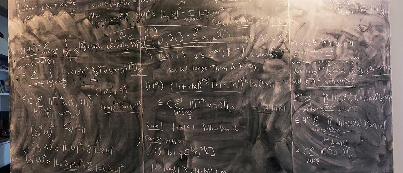 Mathematical equations on a chalkboard.