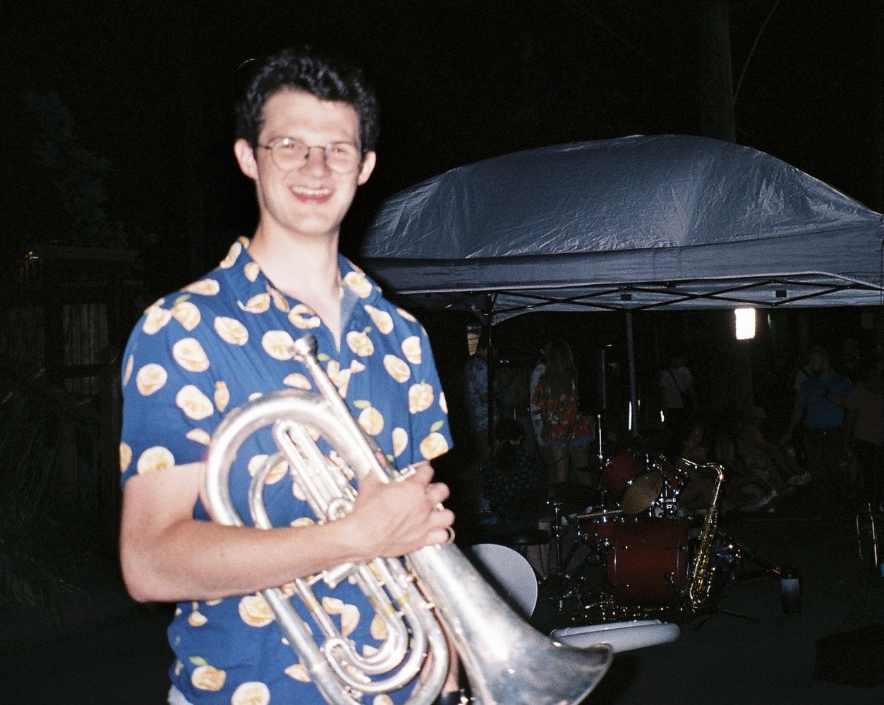 Mike Cummings holding a marching baritone
